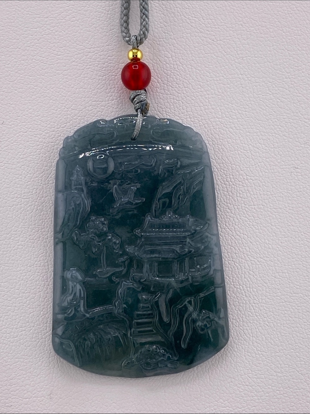 Carved Dark Green Jade Pendant with Red Accent Bead
